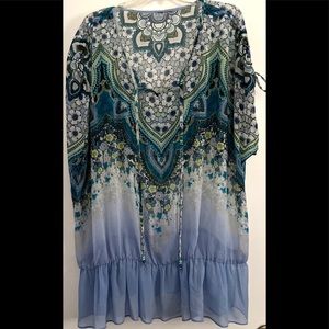 Super lightweight cover all top. Tassels on the neck line and gathered sleeves.